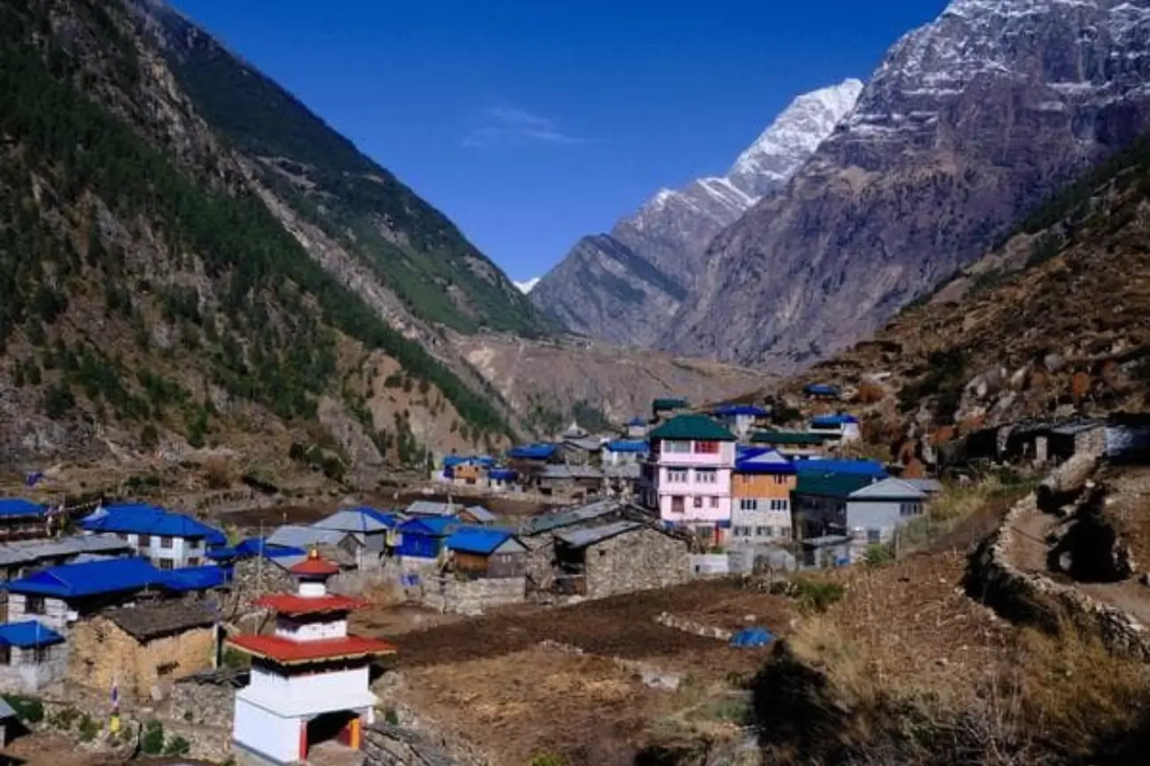 Picturesque mountain village nestled in a deep Himalayan valley during the Annapurna Circuit Trek Tour.